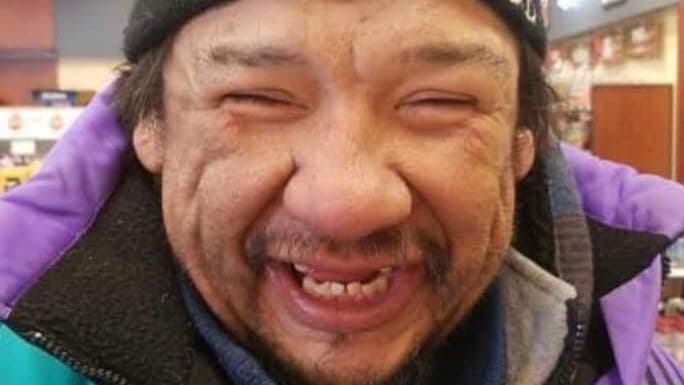 John Ettawakapow is smiling while wearing his winter gear.